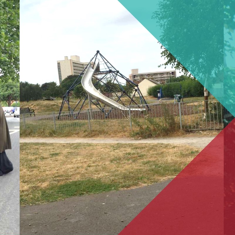 A photograph of a children's playground in a park in an urban area